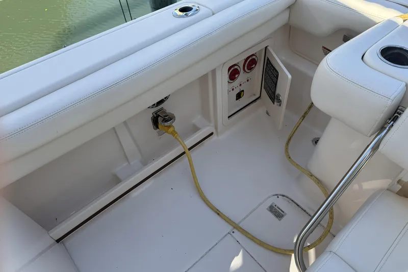 Slide: The Image of 2022 Grady-White Freedom 275 boat interior with power connections and seating. - 29