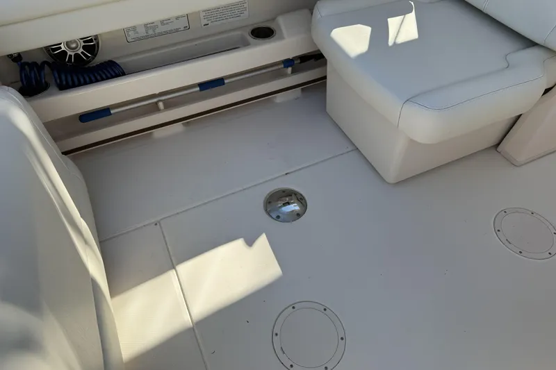 Slide: The Image of 2022 Grady-White Freedom 275 boat on water, surrounded by palm trees and clear blue sky. - 8