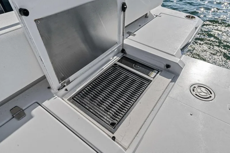 Slide: The Image of Open hatch on 2023 Cruisers 42 Cantius yacht deck, revealing storage compartment. - 19