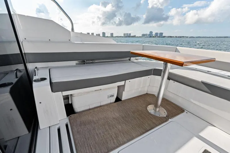 Slide: The Image of 2023 Cruisers 42 Cantius yacht deck with seating and table, ocean view. - 21