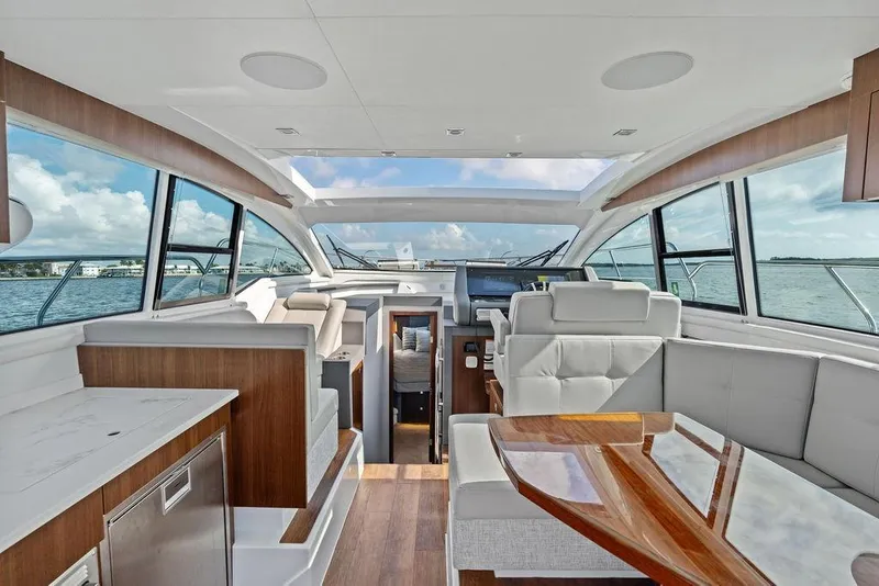 Slide: The Image of Interior of 2023 Cruisers 42 Cantius yacht with modern seating and panoramic windows. - 24