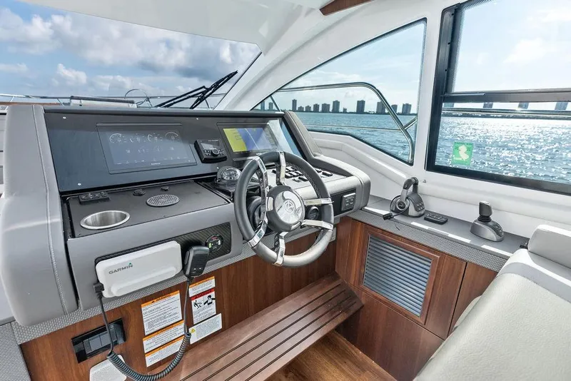 Slide: The Image of 2023 Cruisers 42 Cantius yacht helm with modern controls and ocean view. - 31