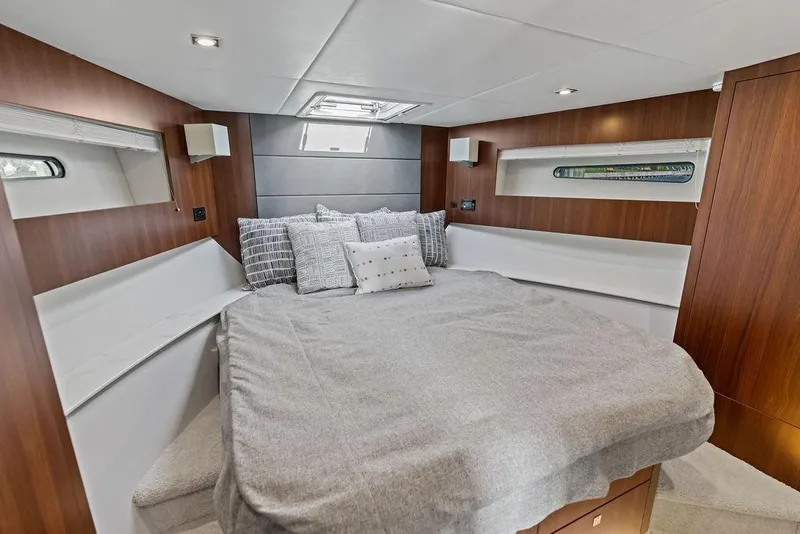 Slide: The Image of Luxurious 2023 Cruisers 42 Cantius yacht bedroom with modern wood paneling and cozy bedding. - 34
