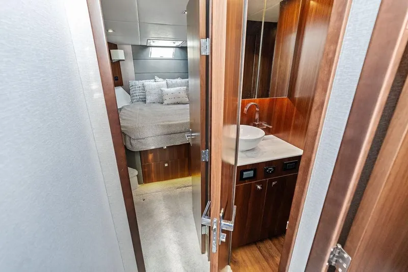 Slide: The Image of 2023 Cruisers 42 Cantius yacht interior with bedroom and bathroom view. - 39