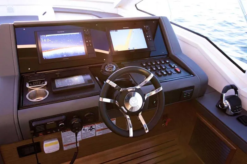 Slide: The Image of Helm of 2023 Cruisers 42 Cantius yacht with modern navigation displays and controls. - 4