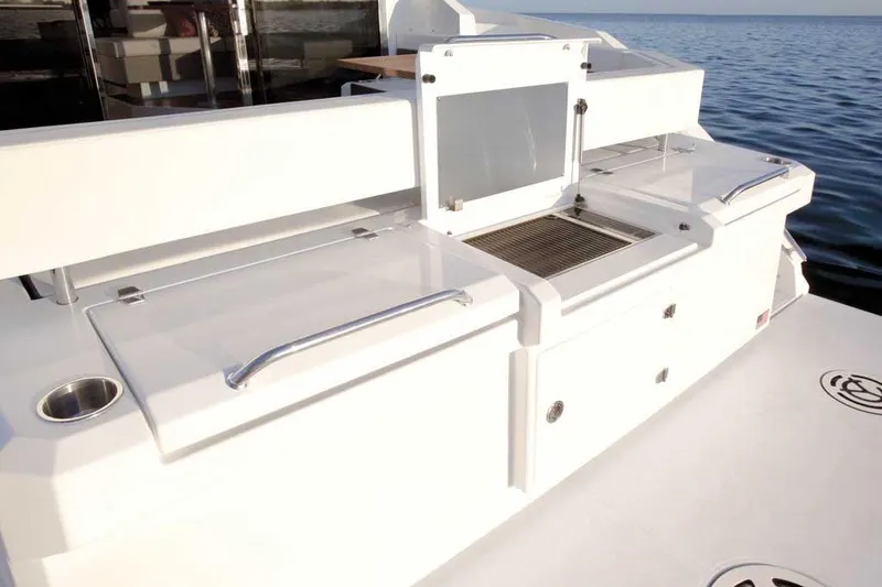 Slide: The Image of 2023 Cruisers 42 Cantius yacht deck with sleek white design and ocean view. - 9