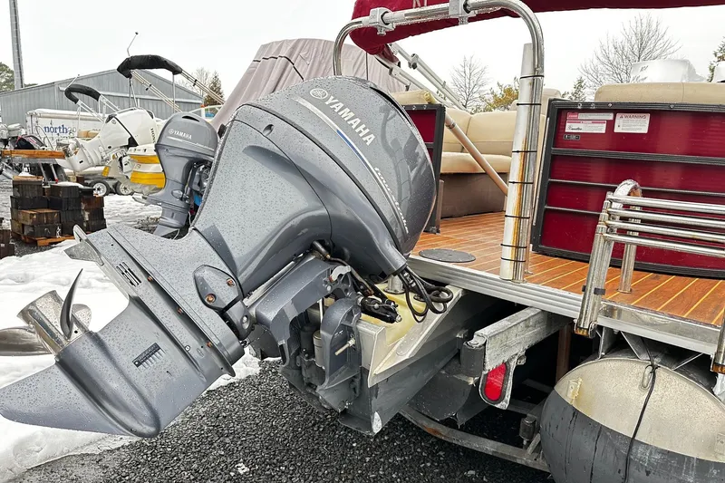 Slide: The Image of 2016 Crest Pontoon SLC OPT with Yamaha outboard motor, parked on a snowy surface. - 10