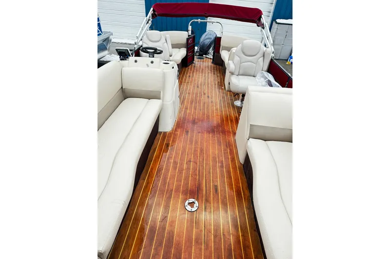Slide: The Image of 2016 Crest Pontoon SLC OPT with spacious seating and wooden deck interior. - 4