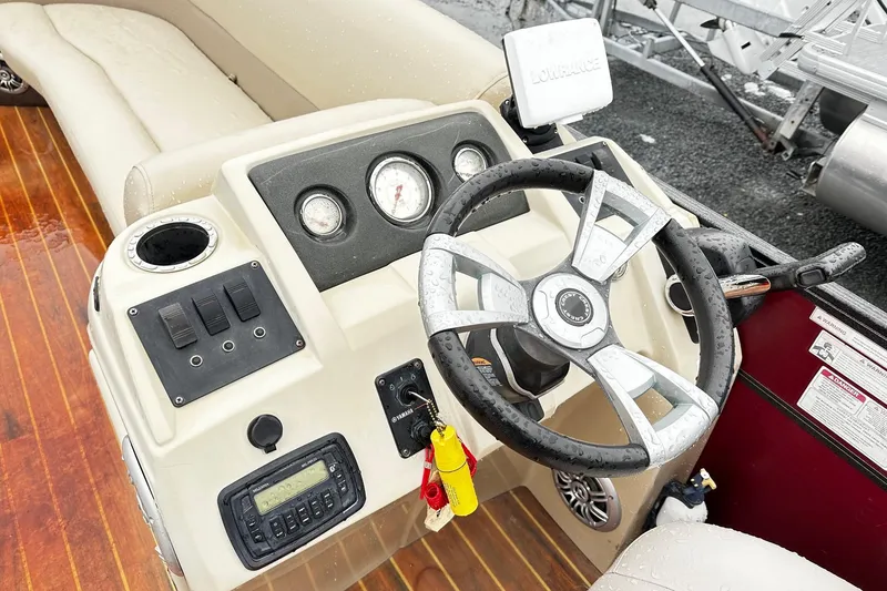 Slide: The Image of 2016 Crest Pontoon SLC OPT dashboard with steering wheel and control panel. - 6