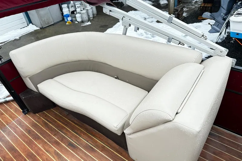 Slide: The Image of 2016 Crest Pontoon SLC OPT with beige seating on wooden deck, snowy background. - 8