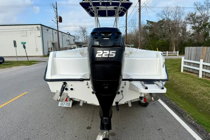 Slide: The Image of 2008 Boston Whaler 210 Outrage boat with 225 horsepower engine on a street. - 3
