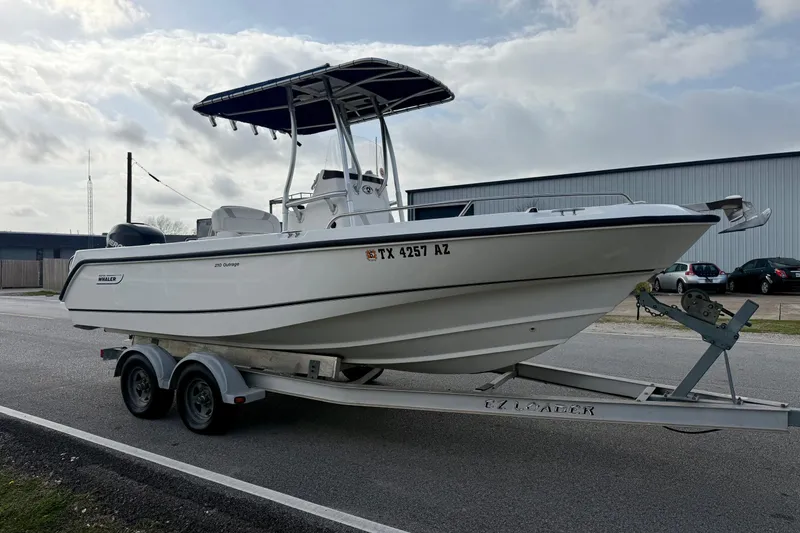 Slide: The Image of 2008 Boston Whaler 210 Outrage boat on trailer, parked outdoors. - 5