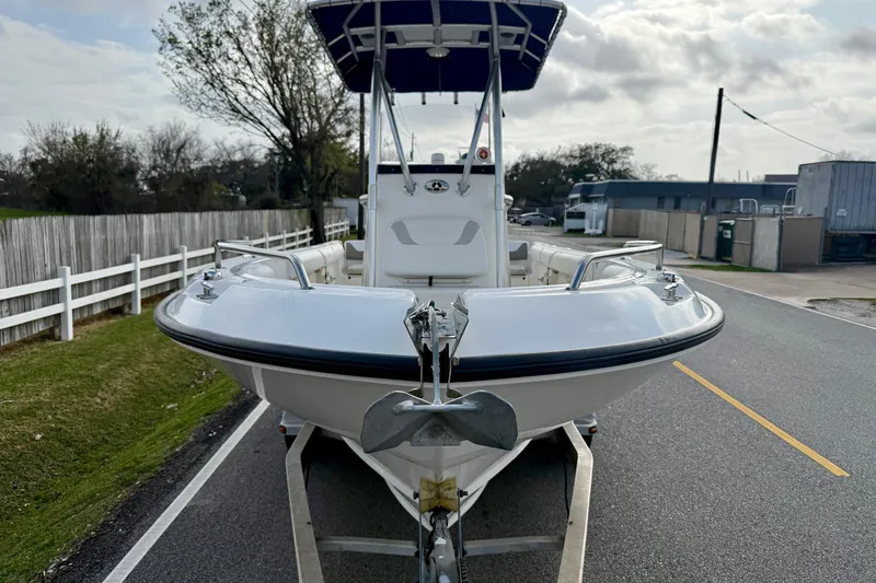 Slide: The Image of 2008 Boston Whaler 210 Outrage boat on trailer, parked on a road. - 6