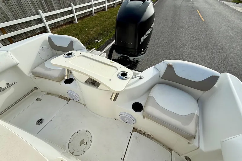 Slide: The Image of 2008 Boston Whaler 210 Outrage boat interior with seating and Mercury engine. - 7