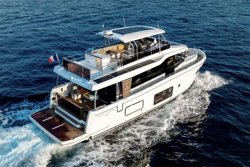 Slide: The Image of Manufacturer Provided Image: 2026 Beneteau Swift Trawler 54 cruising on open water, showcasing elegant design and spacious deck. - 4