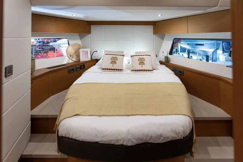 Slide: The Image of Manufacturer Provided Image: Luxurious cabin interior of 2026 Beneteau Swift Trawler 54 with cozy bedding. - 8