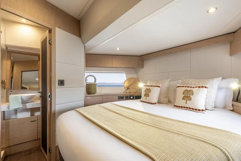 Slide: The Image of Manufacturer Provided Image: Luxurious bedroom in 2026 Beneteau Swift Trawler 54 with elegant decor and natural lighting. - 9