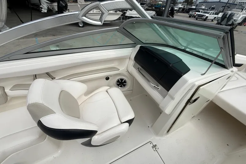 Slide: The Image of 2011 Chaparral 216 SSi Wide Tech boat interior with white seating and dashboard. - 10