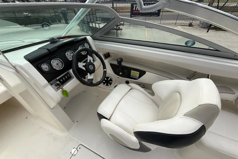 Slide: The Image of 2011 Chaparral 216 SSi Wide Tech boat interior with steering wheel and gauges. - 11