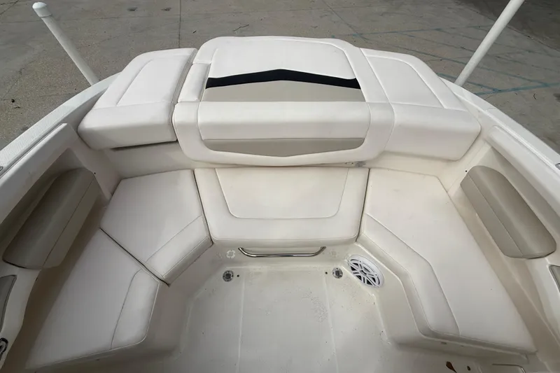 Slide: The Image of 2011 Chaparral 216 SSi Wide Tech boat interior with white cushioned seating. - 12