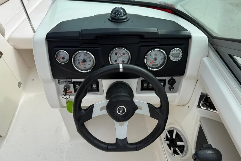 Slide: The Image of Steering wheel and dashboard of 2011 Chaparral 216 SSi Wide Tech boat. - 13