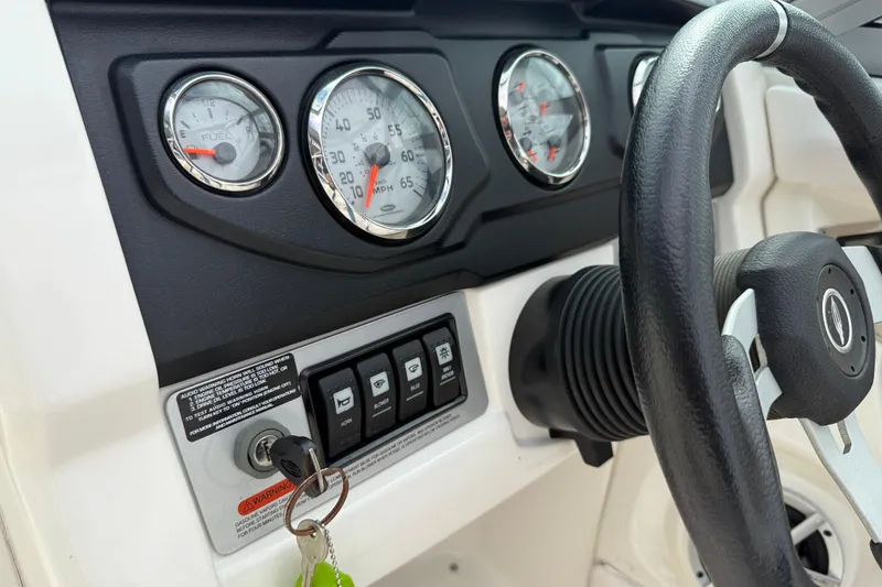 Slide: The Image of Dashboard of 2011 Chaparral 216 SSi Wide Tech boat with gauges and steering wheel. - 14