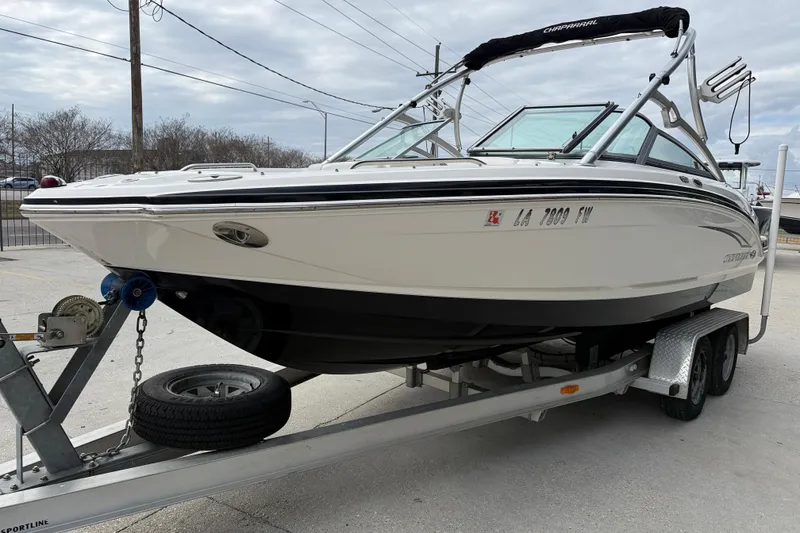 Slide: The Image of 2011 Chaparral 216 SSi Wide Tech boat on trailer, parked outdoors. - 3