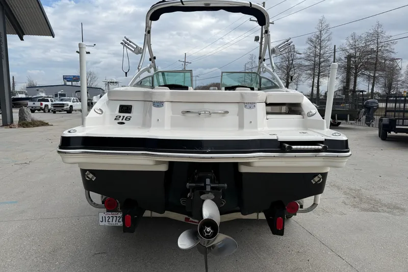 Slide: The Image of 2011 Chaparral 216 SSi Wide Tech boat, rear view, parked outdoors. - 5