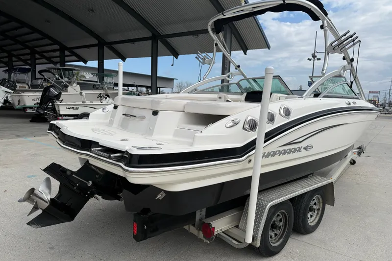 Slide: The Image of 2011 Chaparral 216 SSi Wide Tech boat on trailer in marina setting. - 6
