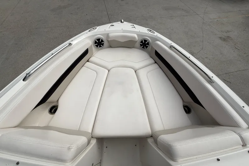 Slide: The Image of 2011 Chaparral 216 SSi Wide Tech boat interior with white cushioned seating. - 9