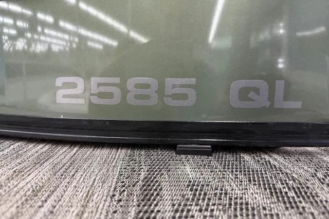 Slide: The Image of 2023 Avalon Catalina 2585 QL model nameplate on textured surface. - 11