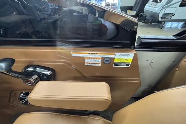 Slide: The Image of Interior view of 2023 Avalon Catalina 2585 QL boat with tan seating and control panel. - 14