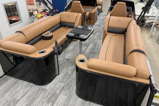 Slide: The Image of 2023 Avalon Catalina 2585 QL pontoon boat interior with luxurious tan seating and sleek design. - 20