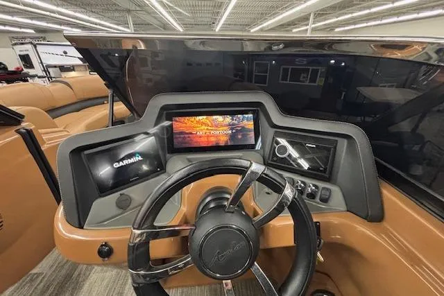 Slide: The Image of 2023 Avalon Catalina 2585 QL dashboard with Garmin display and modern steering wheel. - 28