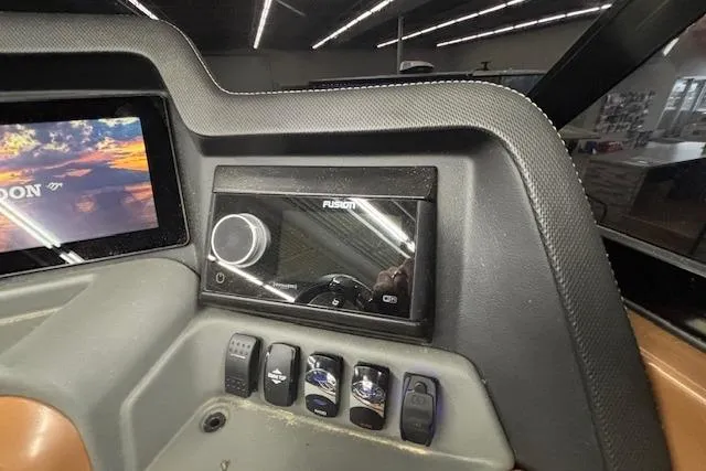 Slide: The Image of Dashboard of 2023 Avalon Catalina 2585 QL with Fusion audio system and control switches. - 29