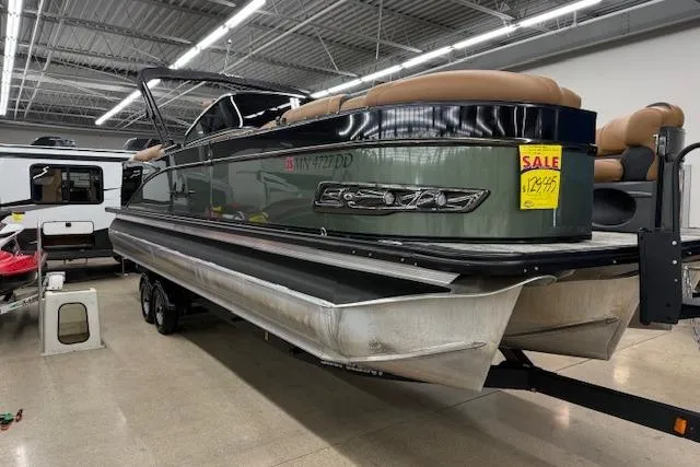 Slide: The Image of 2023 Avalon Catalina 2585 QL pontoon boat on display in showroom, sale sign visible. - 3