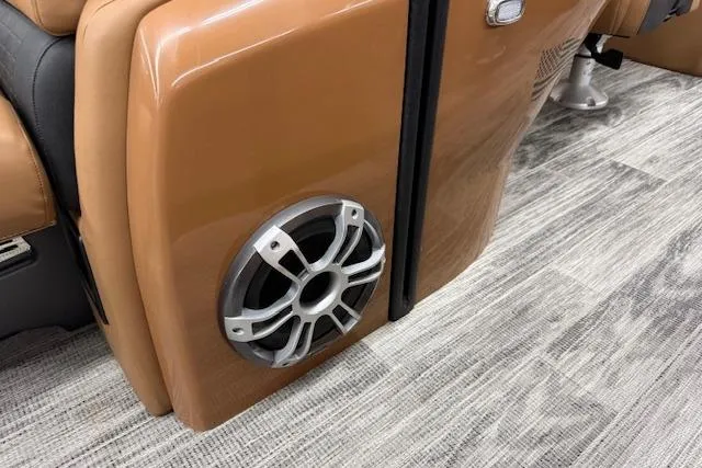 Slide: The Image of 2023 Avalon Catalina 2585 QL boat interior with speaker and tan upholstery. - 34