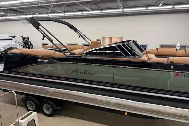Slide: The Image of 2023 Avalon Catalina 2585 QL pontoon boat in showroom, featuring sleek design and luxury seating. - 4