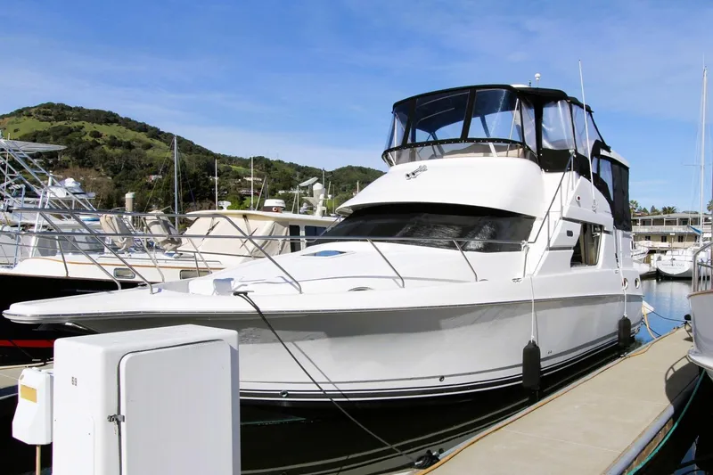 The Image of 1998 Silverton 372 Motor Yacht docked at marina under clear blue sky. - 0