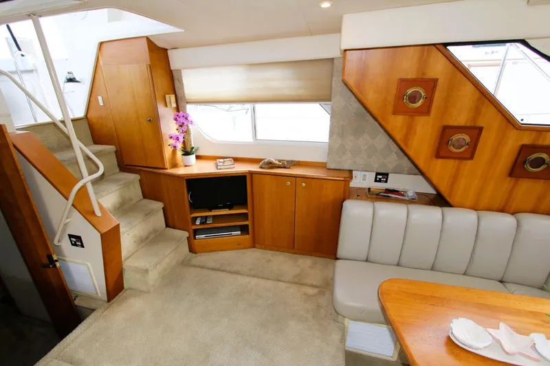 Slide: The Image of Luxurious interior of 1998 Silverton 372 Motor Yacht with wood accents and plush seating. - 12
