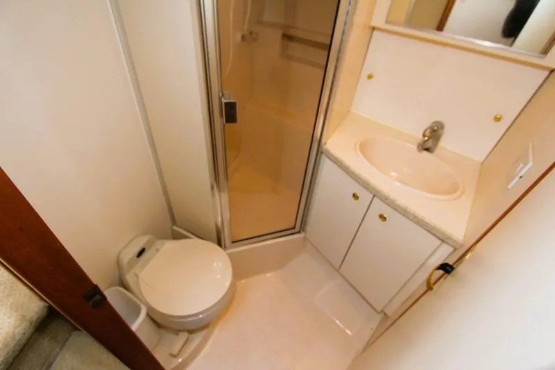 Slide: The Image of 1998 Silverton 372 Motor Yacht bathroom with shower, sink, and toilet. - 17