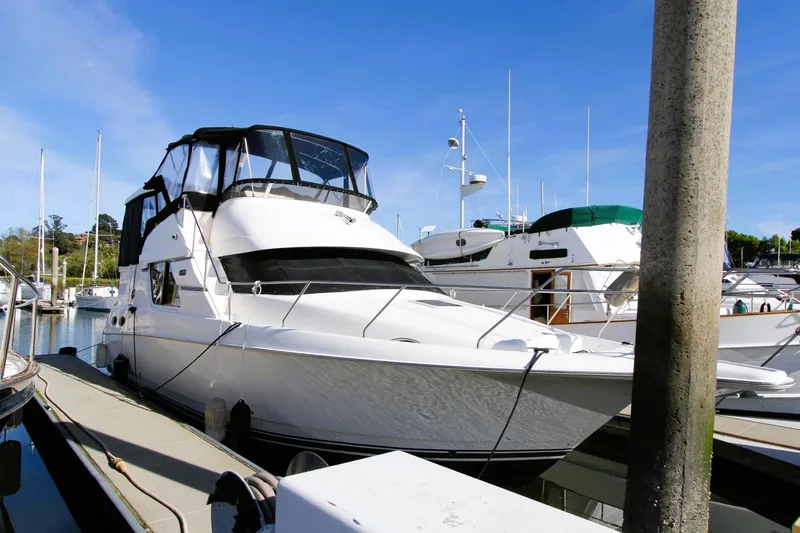Slide: The Image of 1998 Silverton 372 Motor Yacht docked at marina under clear blue sky. - 2