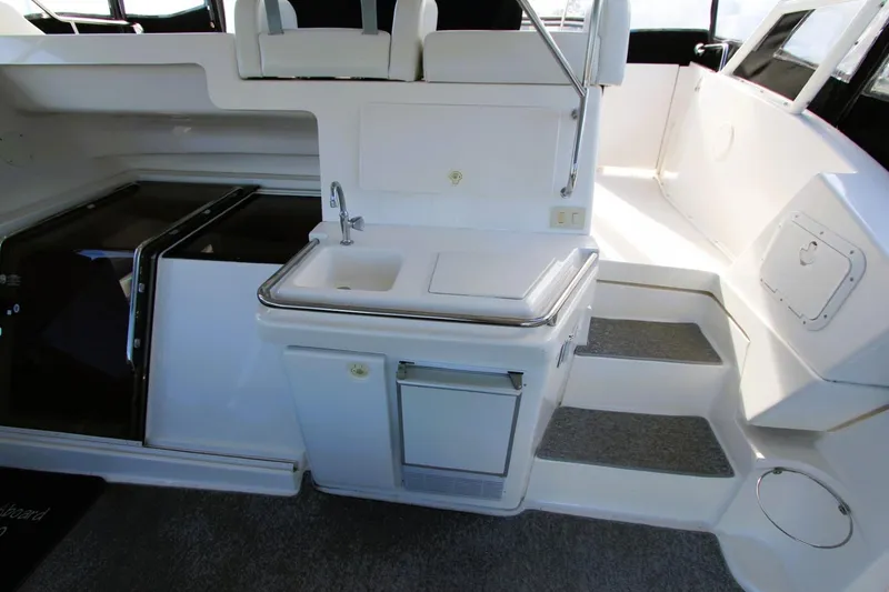 Slide: The Image of 1998 Silverton 372 Motor Yacht interior with sink and seating area. - 27