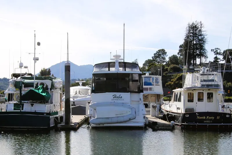 Slide: The Image of 1998 Silverton 372 Motor Yacht docked among other boats in a marina. - 3