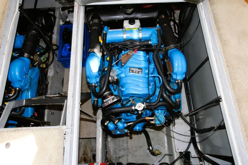 Slide: The Image of Engine compartment of a 1998 Silverton 372 Motor Yacht, featuring a blue engine. - 35