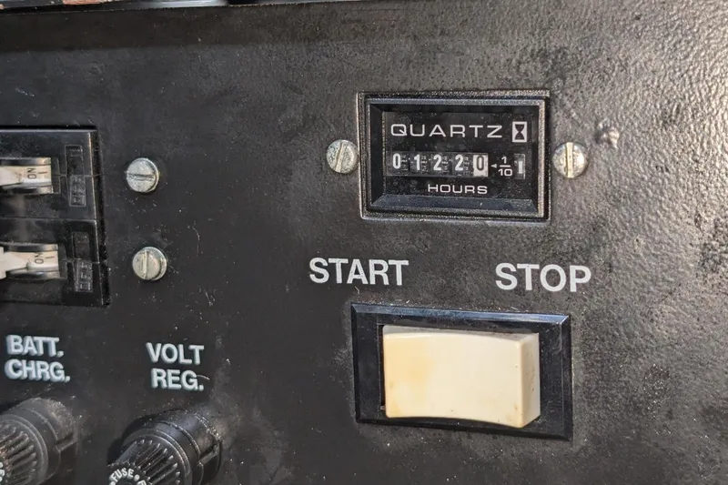 Slide: The Image of Control panel of a 1998 Silverton 372 Motor Yacht with hour meter and switches. - 39