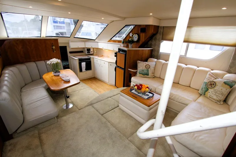 Slide: The Image of Luxurious interior of 1998 Silverton 372 Motor Yacht with plush seating and modern kitchen. - 4