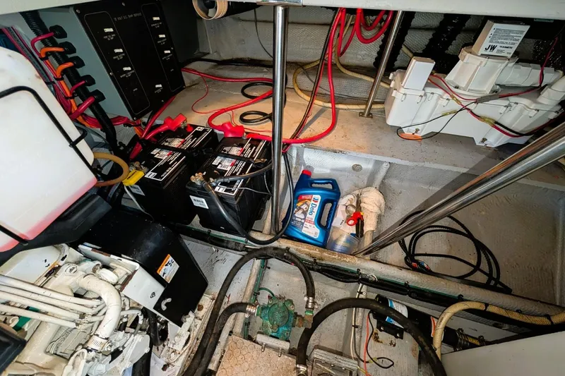 Slide: The Image of Engine room of 1998 Silverton 372 Motor Yacht with batteries and wiring. - 40