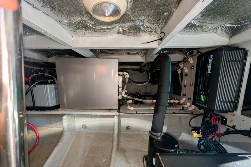 Slide: The Image of 1998 Silverton 372 Motor Yacht engine room with electrical and mechanical components. - 42