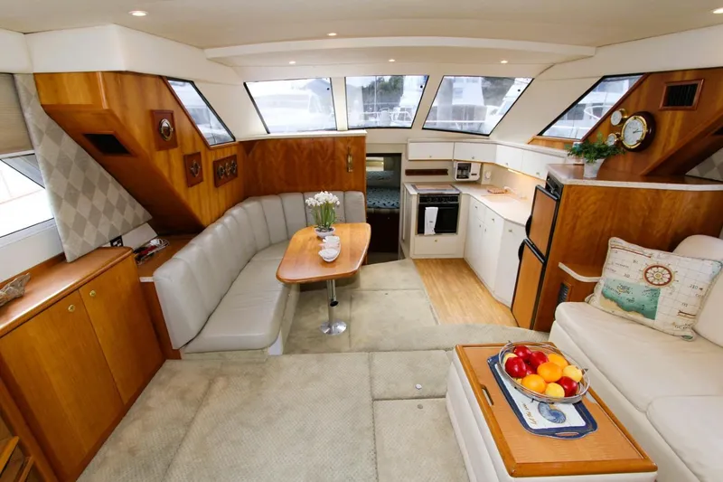 Slide: The Image of Luxurious interior of a 1998 Silverton 372 Motor Yacht with elegant seating and kitchen area. - 5